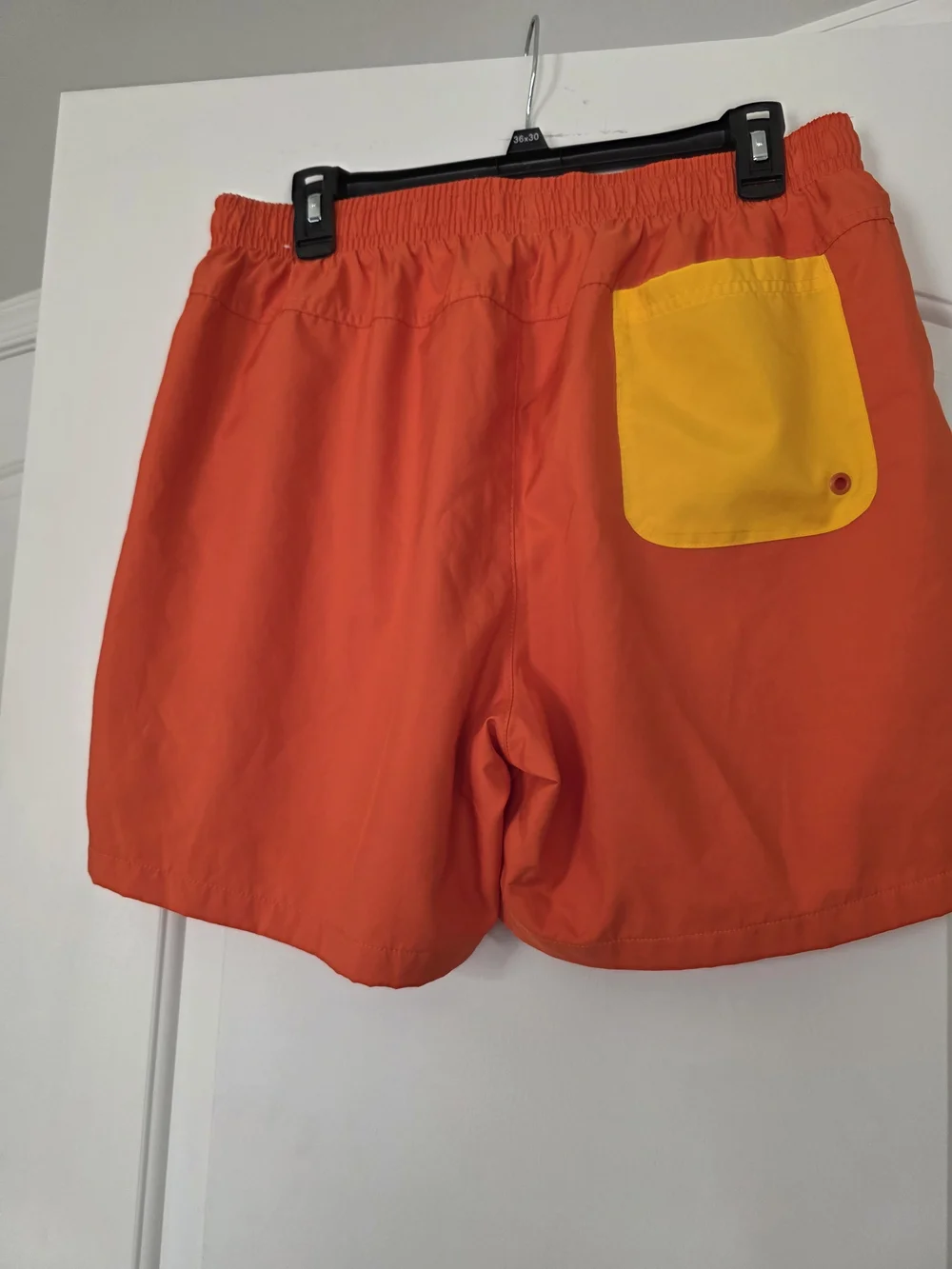 Nike Men's Orange Athletic Shorts with Yellow Drawstring and Logo